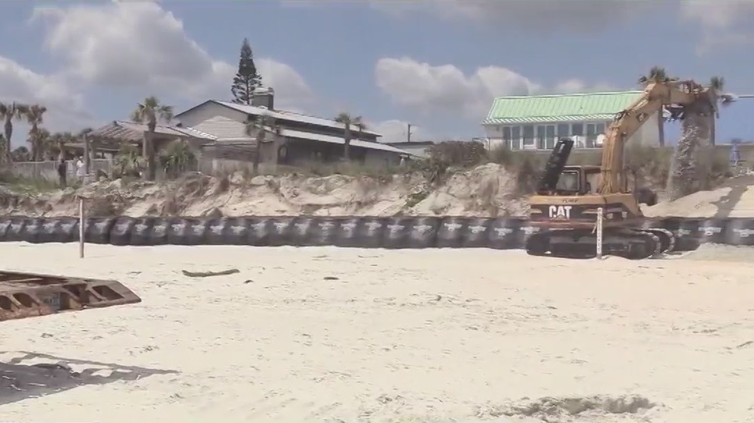 Residents repairing sand dunes themselves