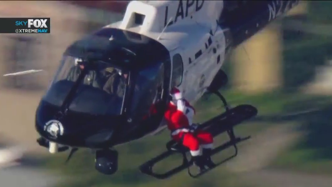 Santa delivers gifts to children, gets ride on LAPD chopper