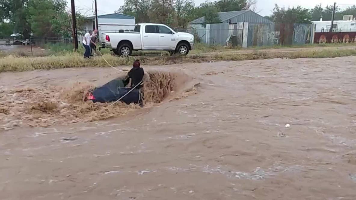 Swift water rescue of driver in nearly submerged car