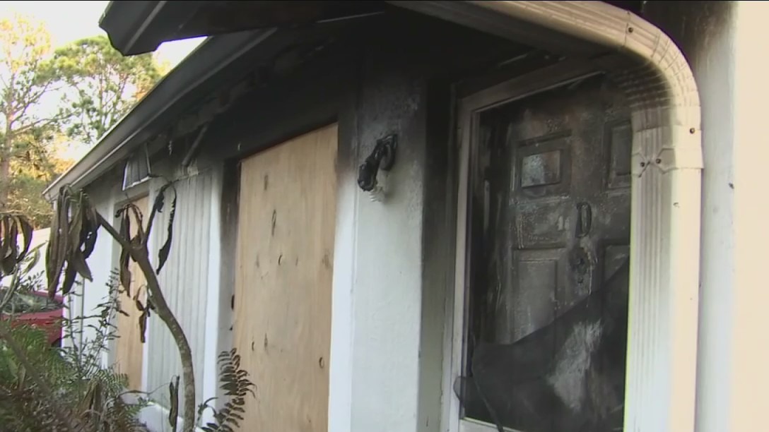 Neighbor tries to save woman from burning home
