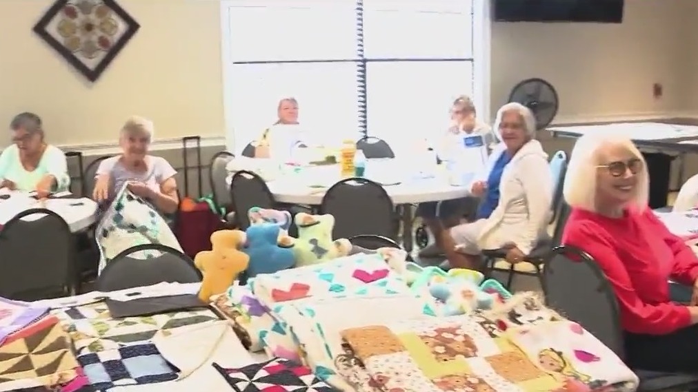 Women crafting quilts for cancer patients