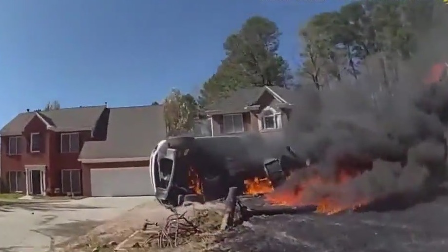 SUV catches fire after flipping in yard in Johns Creek