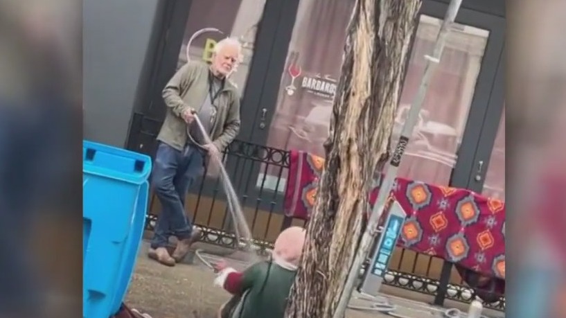 Video: Art gallery owner seen turning hose on homeless woman