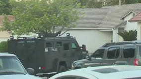 Suspect accused of running over officer killed in shootout