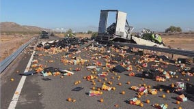 Overturned truck spills load of oranges onto highway