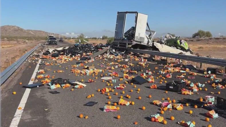 Overturned truck spills load of oranges onto highway