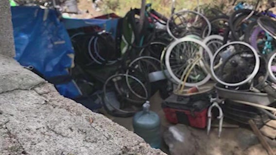 FOX 11 report leads to police raid of stolen bike chop shop in homeless encampment