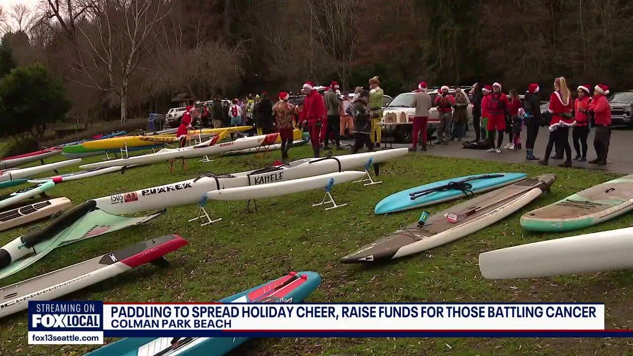 Paddlers spread holiday cheer on Lake Washington during annual Santa Paddle