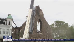 Neighbors watch with sadness the demolition of the building after devastating fire at St Leo's church