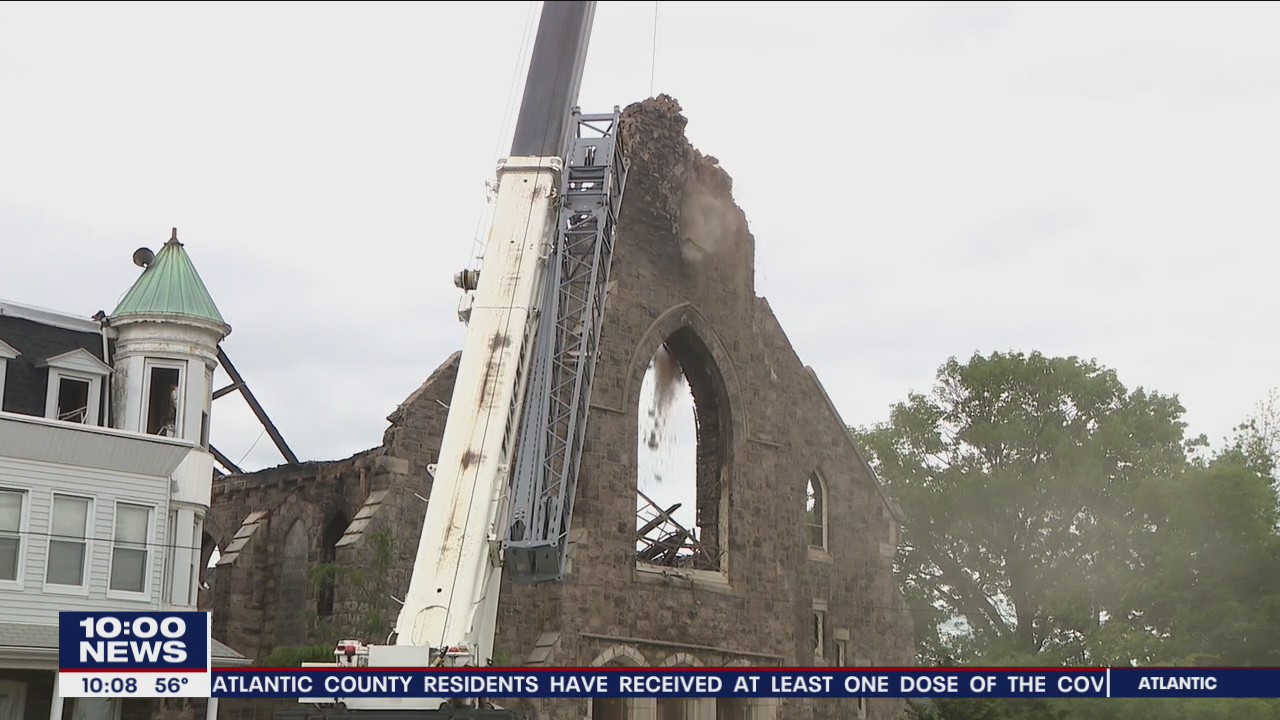 Neighbors watch with sadness the demolition of the building after devastating fire at St Leo's church