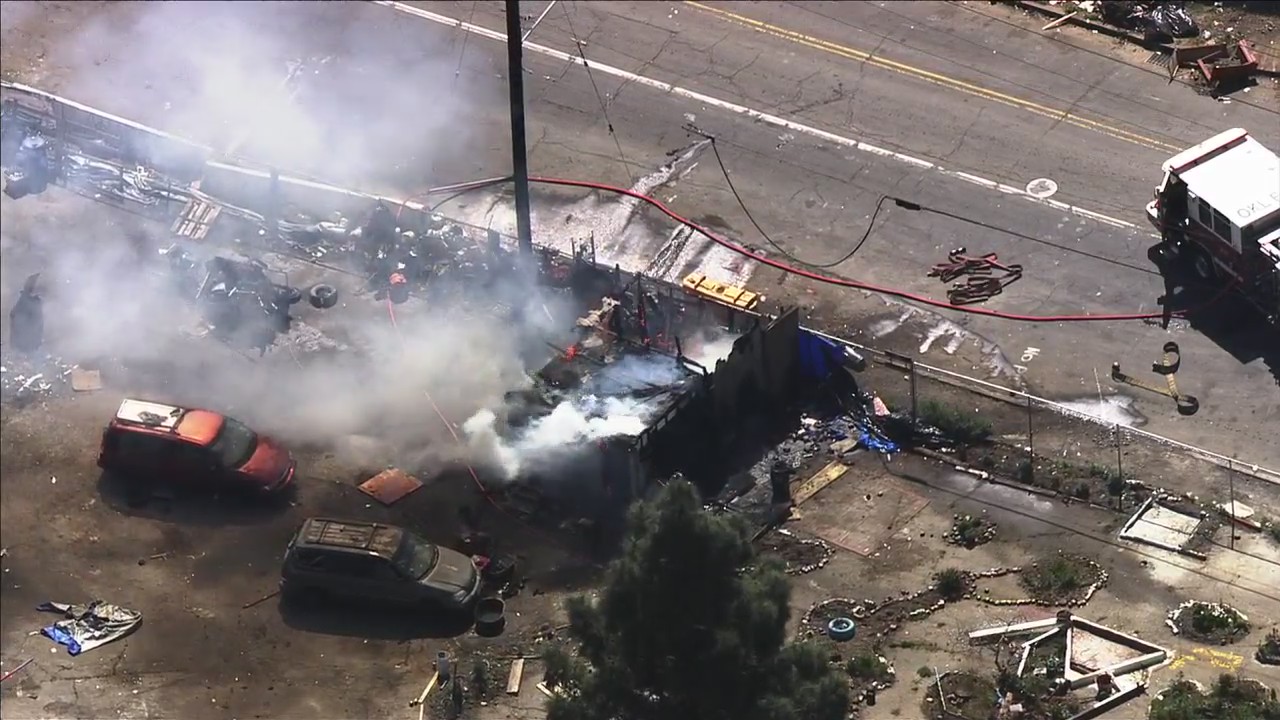 Oakland firefighters battle encampment blaze