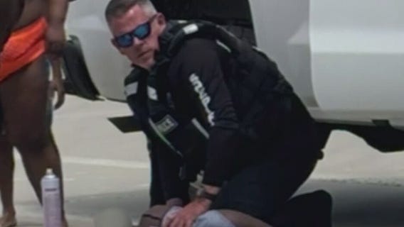 Officer runs into water to save children from rip current