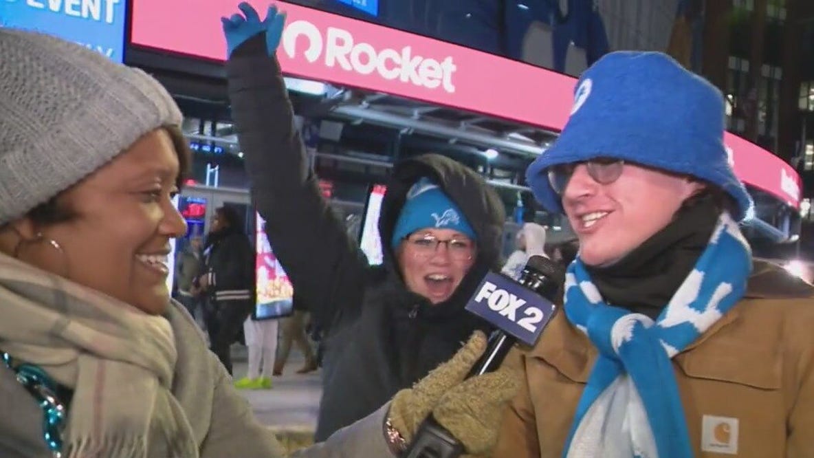 Lions fans celebrate outside of Ford Field after victory over Cowboys