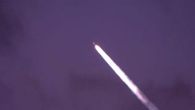 No, they aren't aliens. It's SpaceX