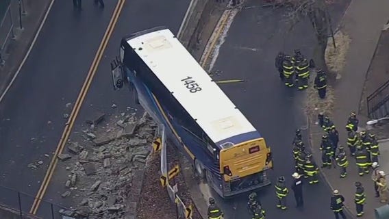 Bus dangles over New York overpass