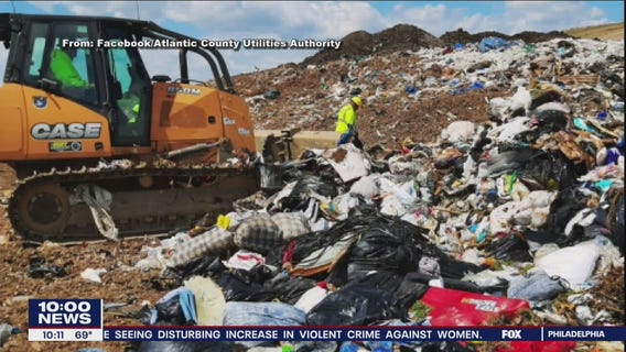 4 AC Utility Authority employees wade through trash seeking customer's wedding ring