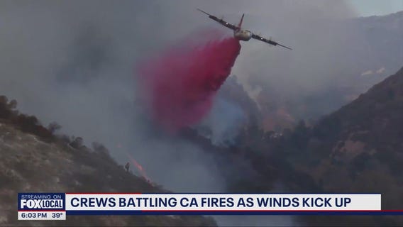 Crews battling CA fires as winds kick up