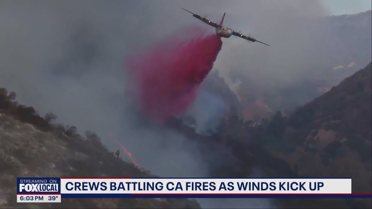 Crews battling CA fires as winds kick up