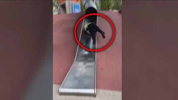 Cop goes viral for his trip down playground slide