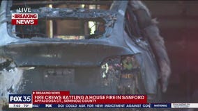 Firefighters battle house fire in Sanford