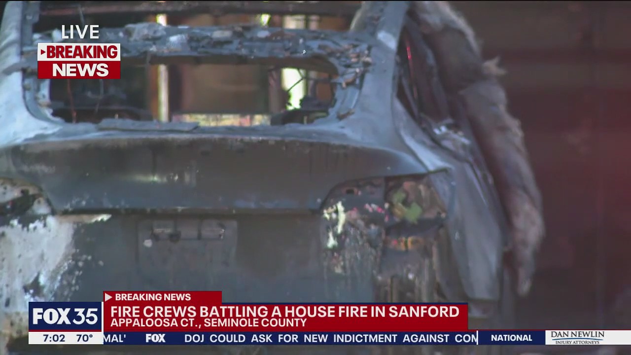 Firefighters battle house fire in Sanford