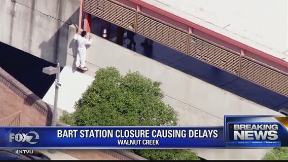 Man threatening to jump closes BART station.