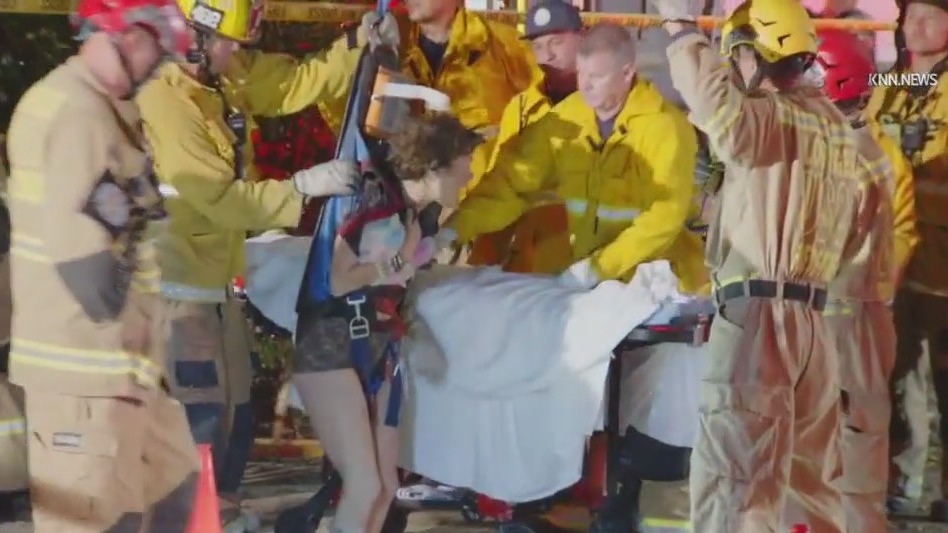 Woman rescued from manhole