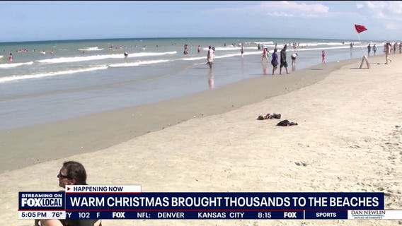 Warm Christmas brings thousands to the beach