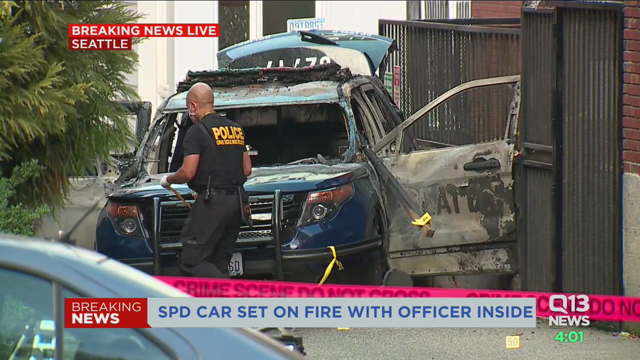 Man arrested after Seattle Police car set on fire with officer inside ...