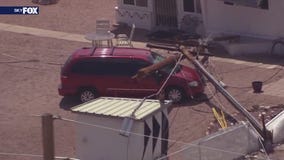 Power pole crashes into van, house in Apache Junction