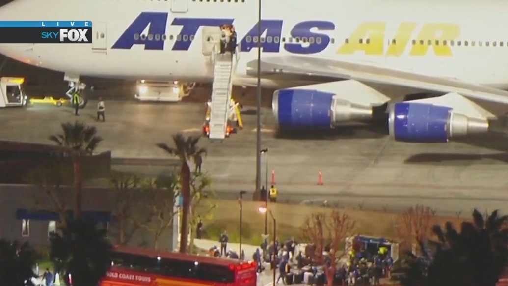 Dodgers return from Tokyo