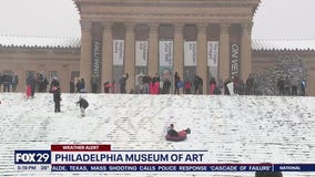 Snow day means sledding on art museum steps