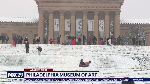 Snow day means sledding on art museum steps