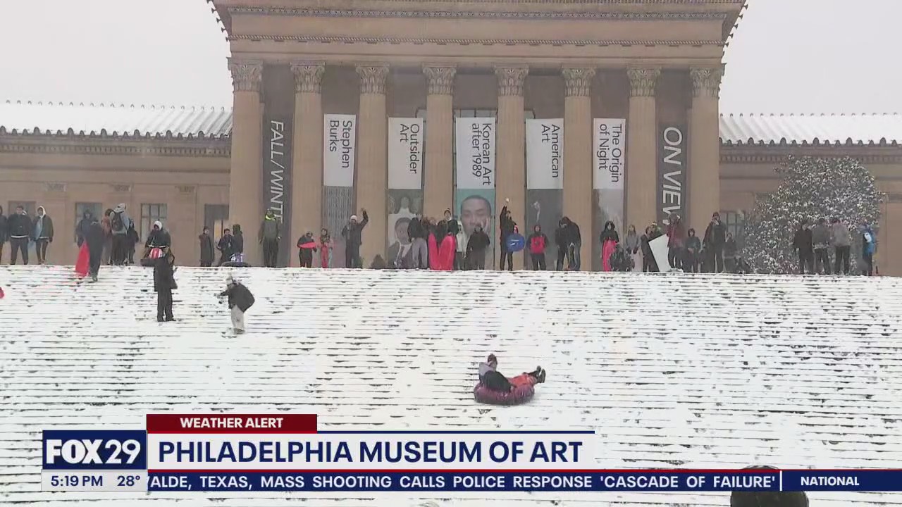 Snow day means sledding on art museum steps