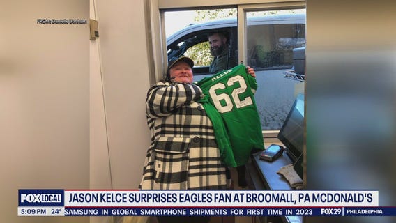 Jason Kelce autographs jersey for McDonald's employee