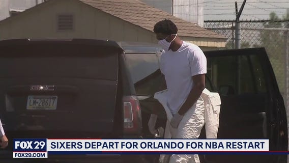 Sixers' Embiid wears coverall suit as team heads to Orlando for continuation of NBA season