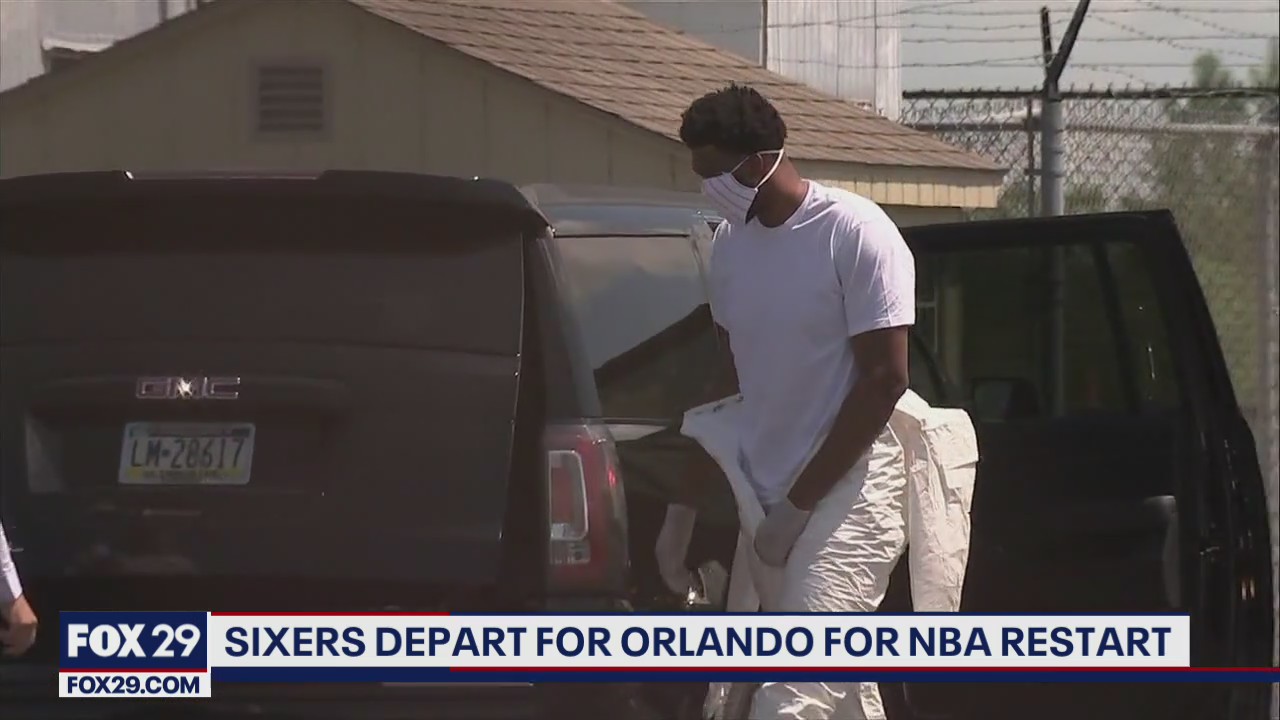 Sixers' Embiid wears coverall suit as team heads to Orlando for continuation of NBA season