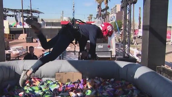 Trying out the human claw at the Super Bowl Experience