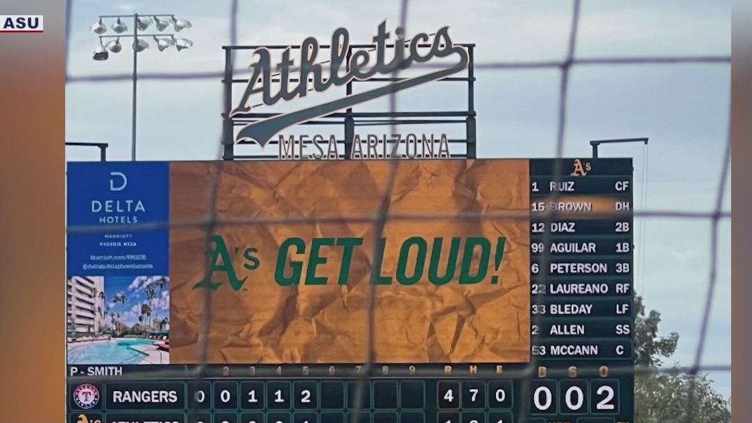 Arizona State University students help update scoreboard for Spring Training