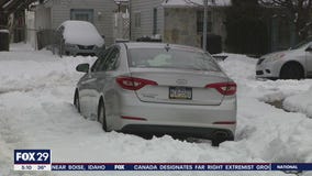 Residents struggle to dig out after nor'easter drops up to a foot of snow