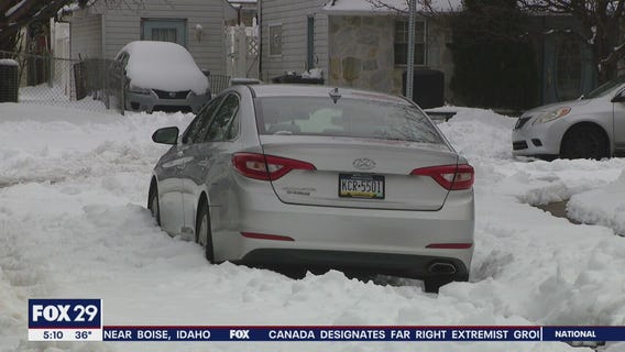 Residents struggle to dig out after nor'easter drops up to a foot of snow