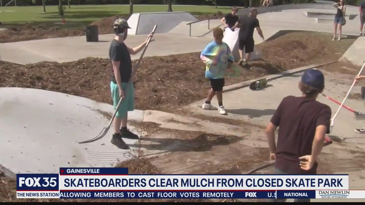 Skateboarders clear mulch from closed skate park
