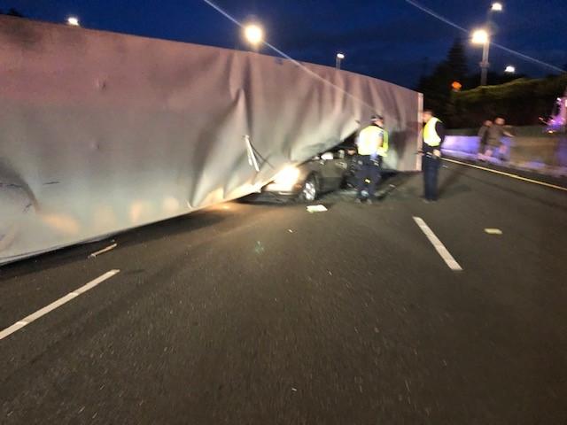 Semi overturns and lands on top of vehicle on I-5