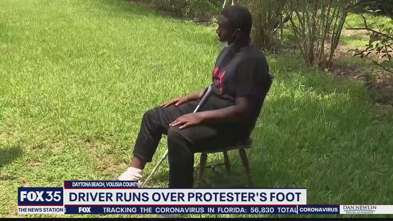Report: Driver ran over protester's foot