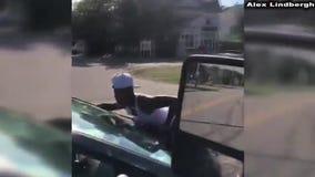 Woman clings to moving car in Virginia