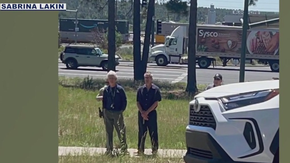 New photos show husband leading police to wife's body