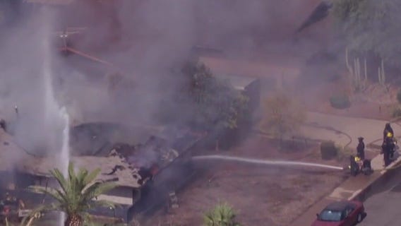 SWAT team surrounds burning home in Tempe