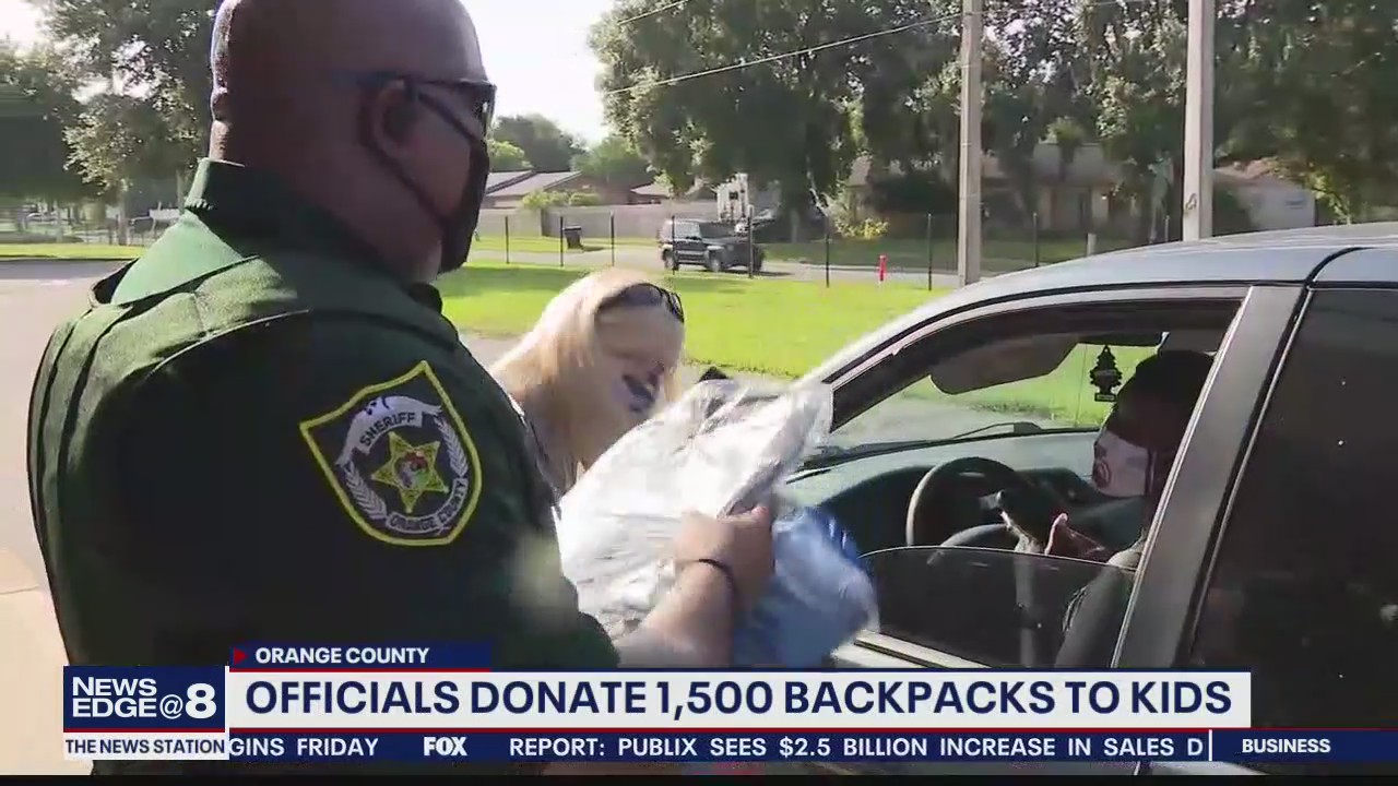 Officials hand out backpacks