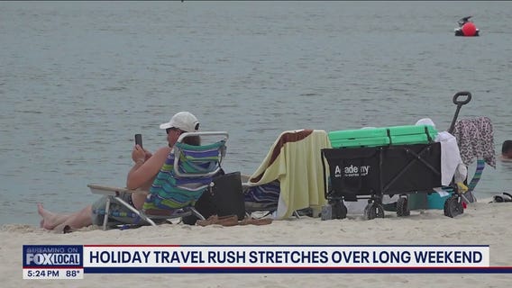 Holiday travel rush stretches over long weekend