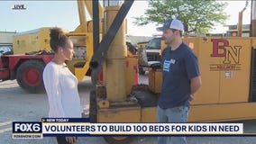 Volunteers pitch in to build 100 beds for kids in need